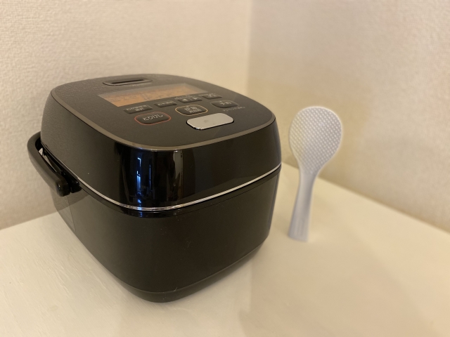 Japanese rice cooker and rice paddle in a home kitchen