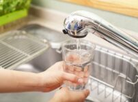 Filling a glass with Japanese tap water at a kitchen sink