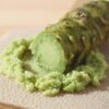 What is wasabi? Freshly grated hon-wasabi rhizome on a traditional grater