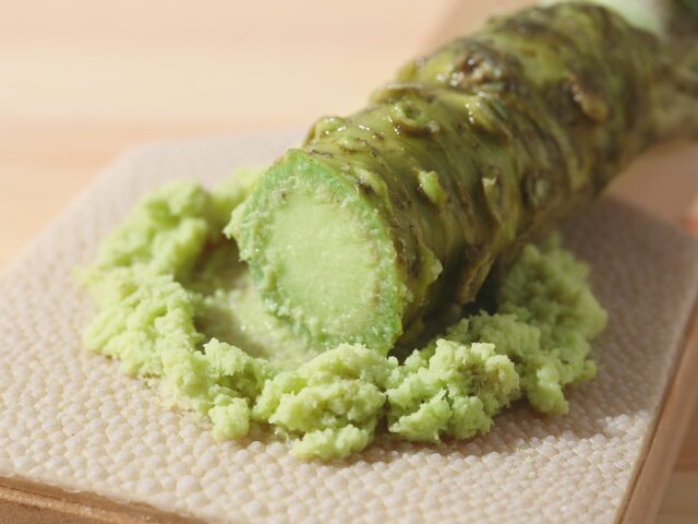 What is wasabi? Freshly grated hon-wasabi rhizome on a traditional grater