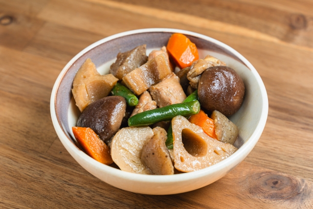 Japanese simmered vegetables with lotus root, shiitake mushrooms, carrots, and konnyaku, a common type of nimono made with dashi.