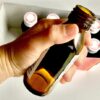 tiny brown bottle of Japanese nutritional drink being opened by hand