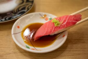 Placing real wasabi directly on sashimi instead of mixing it into soy sauce