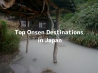 Steamy outdoor onsen bath surrounded by rocks and greenery, with text “Top Onsen Destinations in Japan”