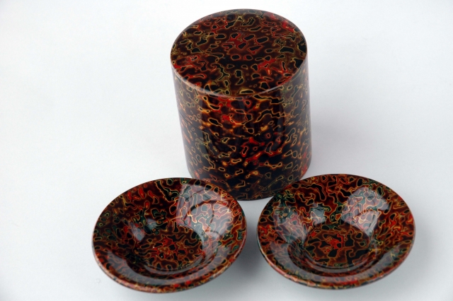 Decorative Japanese tea canister with lacquered cups in a Tsugaru-nuri style.