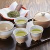 Gyokuro served in small porcelain cups with a kyusu teapot on a wooden tray