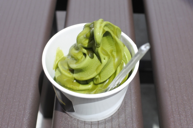 Matcha soft serve ice cream in a paper cup