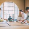 Japanese tea ceremony showing a host serving guests in a traditional tatami room