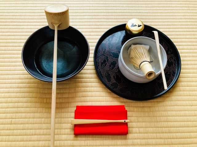 Traditional tea ceremony utensils arranged neatly on tatami