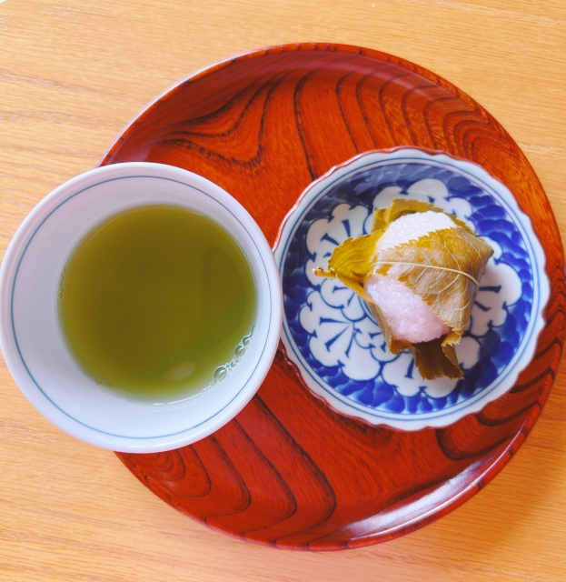 Japanese green tea served with sakura mochi as a traditional tea and sweet pairing.