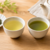 Two cups of Japanese green tea side by side, showing the lighter color of sencha and the deeper green color of fukamushi-cha