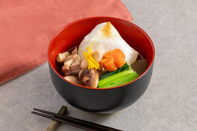 Japanese ozoni soup with mochi, chicken, vegetables, and yuzu peel