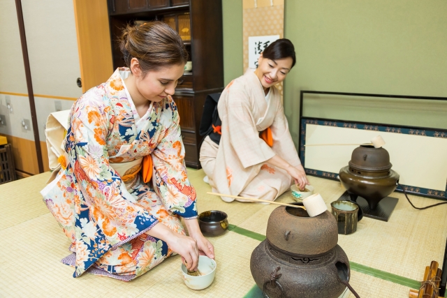 Travelers taking part in a Japanese tea ceremony experience