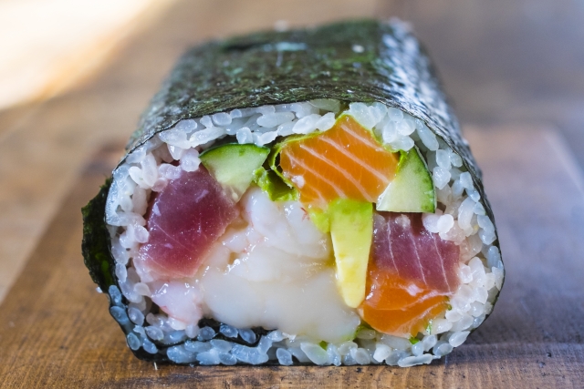 Close-up of an ehomaki sushi roll showing colorful fillings