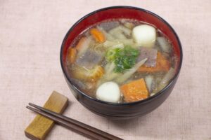 Bowl of kenchinjiru vegetable soup with chopsticks beside it