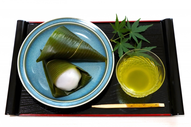 Serving tray with wagashi sweets and a glass of chilled green tea