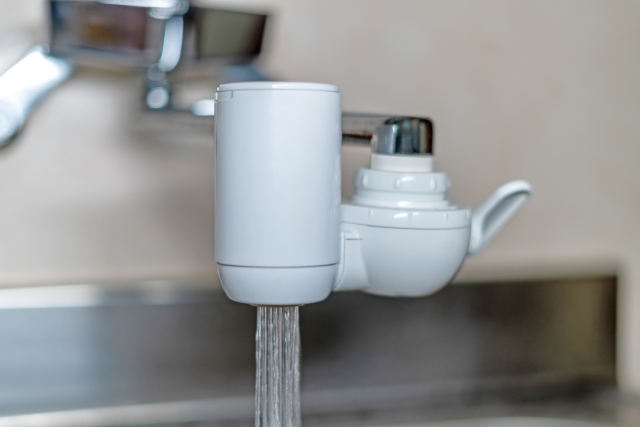 A water filter attached to a kitchen faucet in Japan