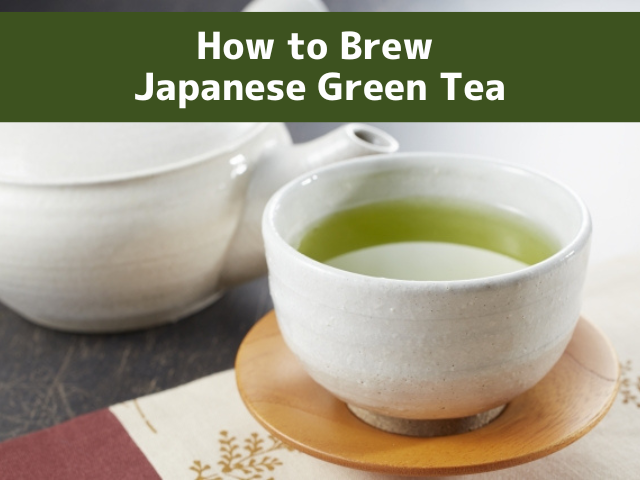 A cup of Japanese green tea served in a yunomi cup beside a kyusu teapot