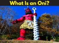 Large red oni statue holding an iron club, wearing tiger-skin pants, symbolizing fear and power in Japanese folklore
