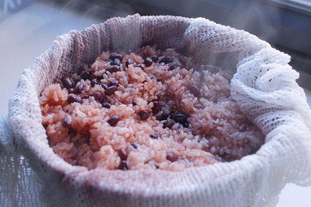 Freshly steamed sekihan showing glutinous rice naturally colored by red beans during cooking.