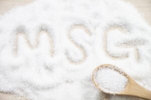 Monosodium glutamate crystals with the letters MSG written in the seasoning.