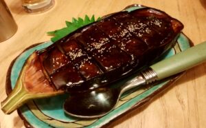 Grilled eggplant coated with a glossy sweet miso glaze, served as nasu dengaku.