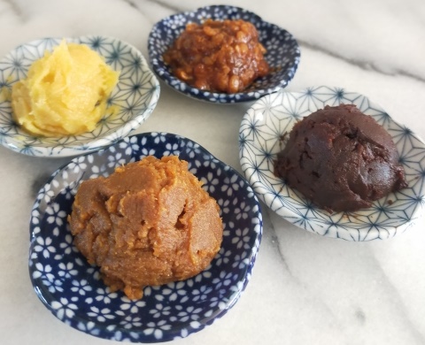 different regional varieties of Japanese miso paste with varying colors and textures