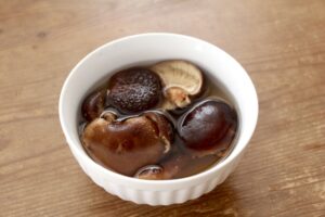Rehydrated shiitake mushrooms and the soaking liquid used as shiitake dashi