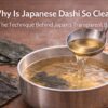 Clear Japanese dashi broth being ladled from a pot with kombu and katsuobushi ingredients beside it