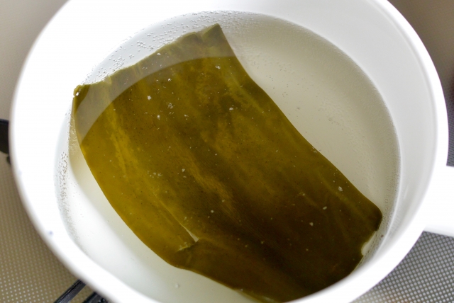 kombu placed in hot pot broth to build umami