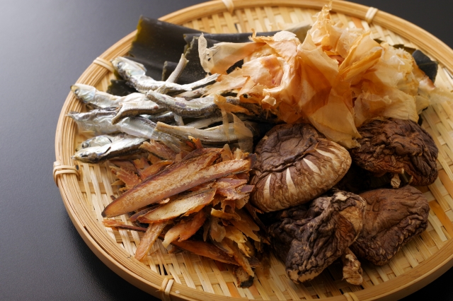 Traditional dashi ingredients including kombu, katsuobushi, niboshi, and dried shiitake mushrooms