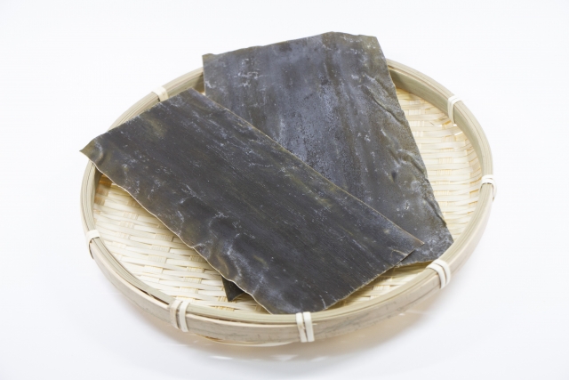 dried kombu kelp sheets on a bamboo tray