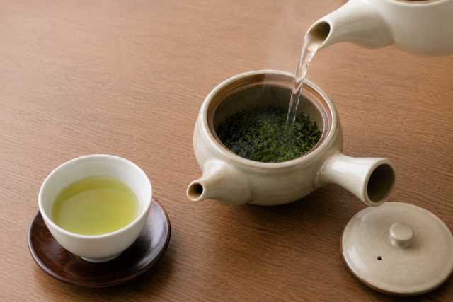 Hot water being poured into a kyusu with already-used Japanese green tea leaves for a second infusion