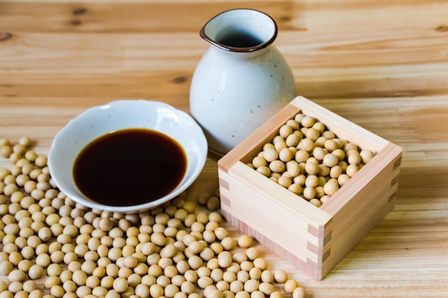 Tamari soy sauce with soybeans and a traditional soy sauce bottle
