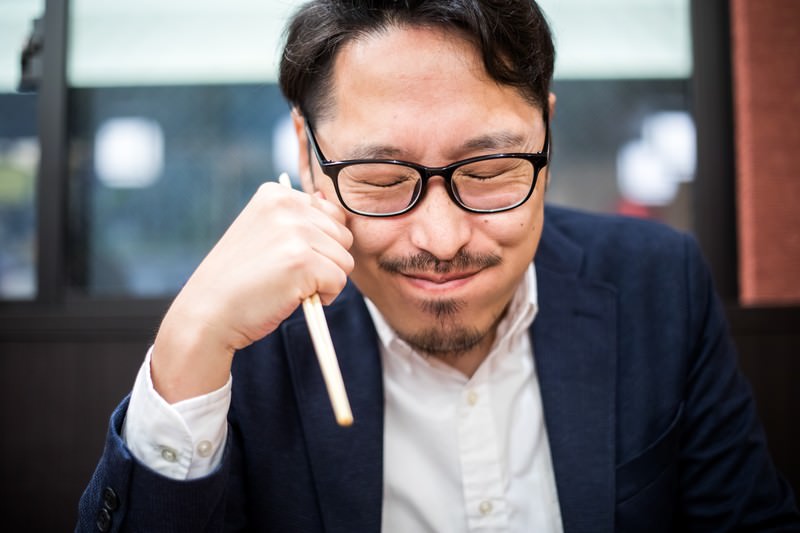 Man tasting Japanese food and reacting to the rich umami flavor