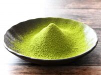 Bright green matcha powder in a bowl showing fine texture for use in desserts