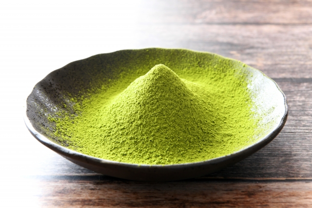 Bright green matcha powder in a bowl showing fine texture for use in desserts