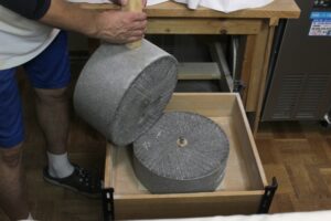 Disassembled stone mill showing upper and lower grinding stones