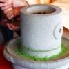 Traditional stone mill grinding matcha tea leaves slowly