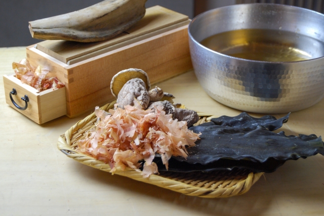 Kombu, katsuobushi, dried shiitake, a bonito shaving box, and a pot of Japanese dashi.