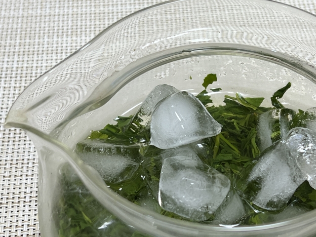 Japanese green tea leaves and ice slowly extracting in a glass pot for koridashi