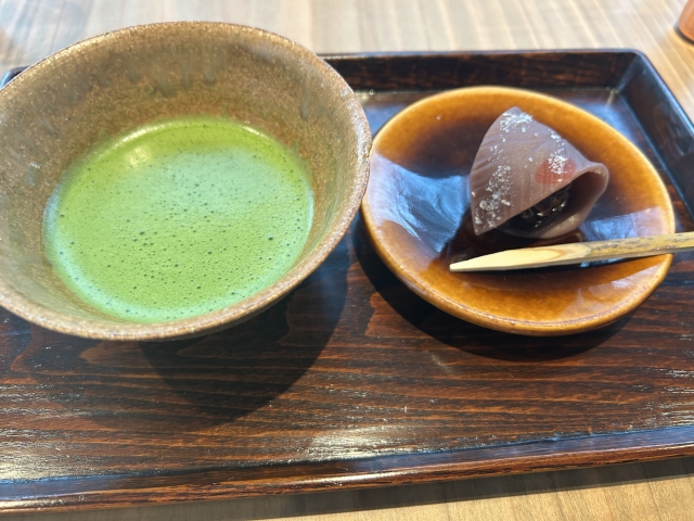Matcha tea served with red bean wagashi on a tray