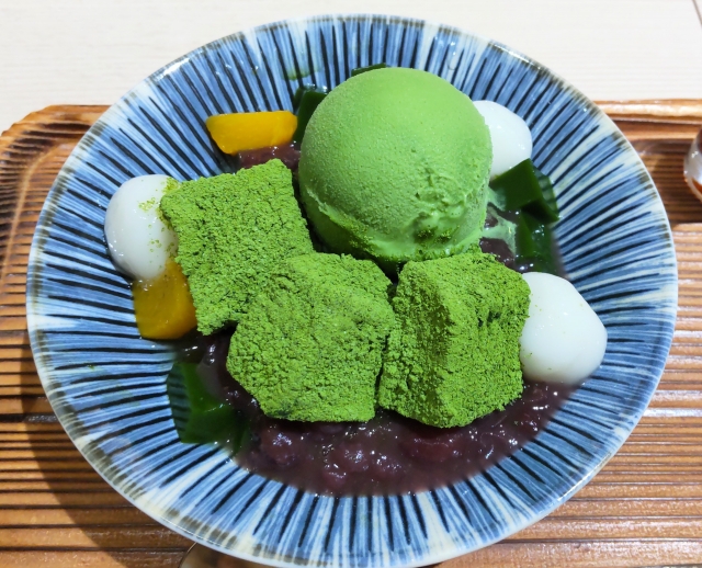 Matcha dessert with ice cream, red bean paste, and mochi in a bowl