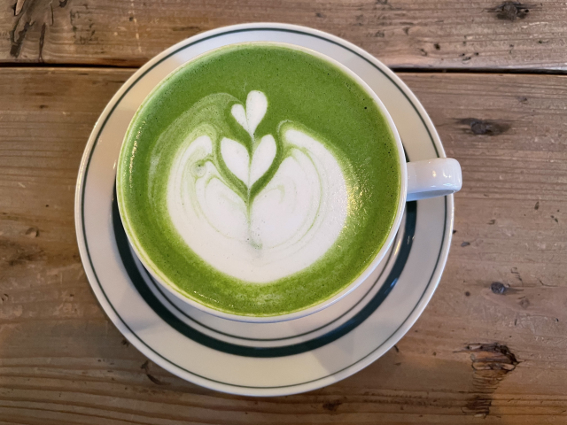 Matcha latte with milk foam showing green and white contrast