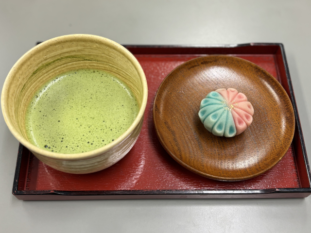 Bowl of matcha served with a traditional Japanese wagashi