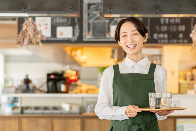 Restaurant staff serving water to customers in Japan