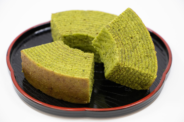 Matcha baumkuchen cake sliced on a black plate