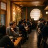 Busy Japanese restaurant with many customers dining quietly in a warm and relaxed atmosphere despite the restaurant being nearly full