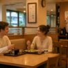 Foreign couple quietly enjoying a meal in a calm Japanese family restaurant while staff keep a respectful distance