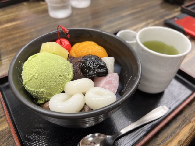 Japanese matcha dessert with matcha ice cream, azuki, shiratama, fruit, and green te